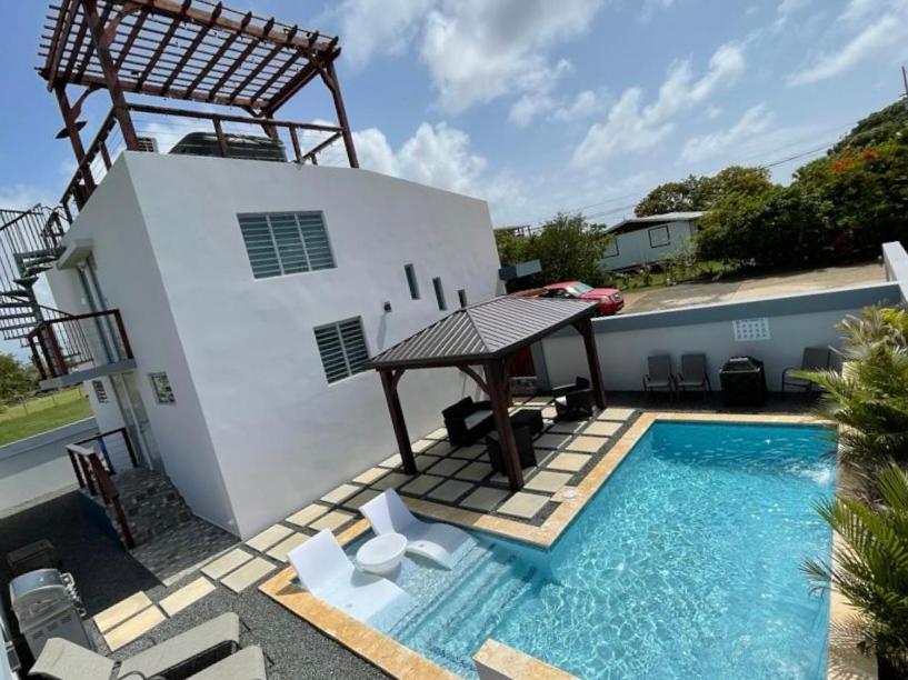 a house with a swimming pool next to a building at Sunset Coast Loft & Rooftop in Aguacate