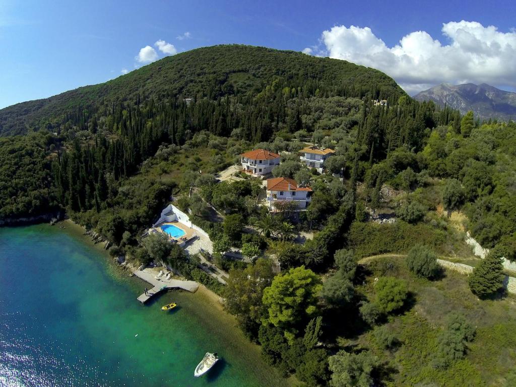 an aerial view of a house on a hill next to the water at Korakias SeaView in Yénion