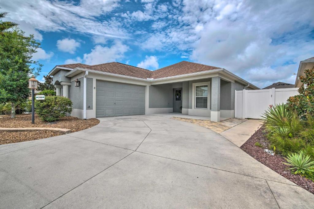 a house with a driveway in front of it at Swim in Pools and Play Golf Eleanor Villages Home in Wildwood