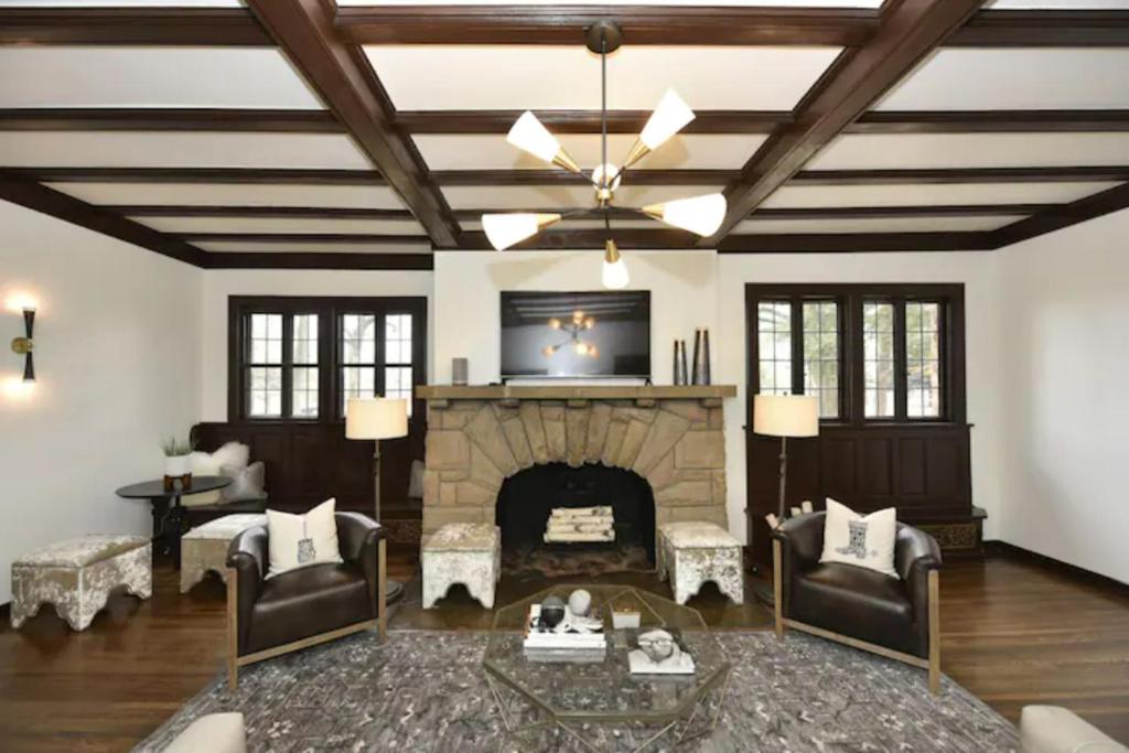 a living room with a fireplace and a ceiling at The Howe House in Nashville