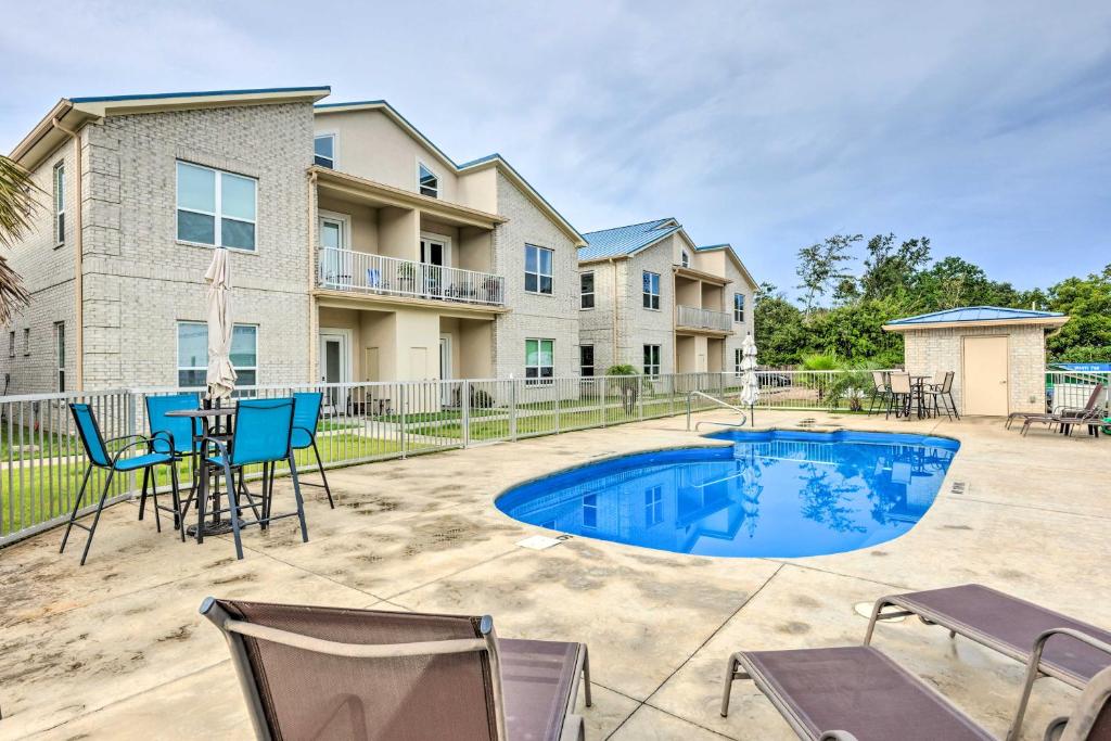 a patio with a table and chairs and a swimming pool at Modern Long Beach Escape about 1 Mi to Shores! in Long Beach