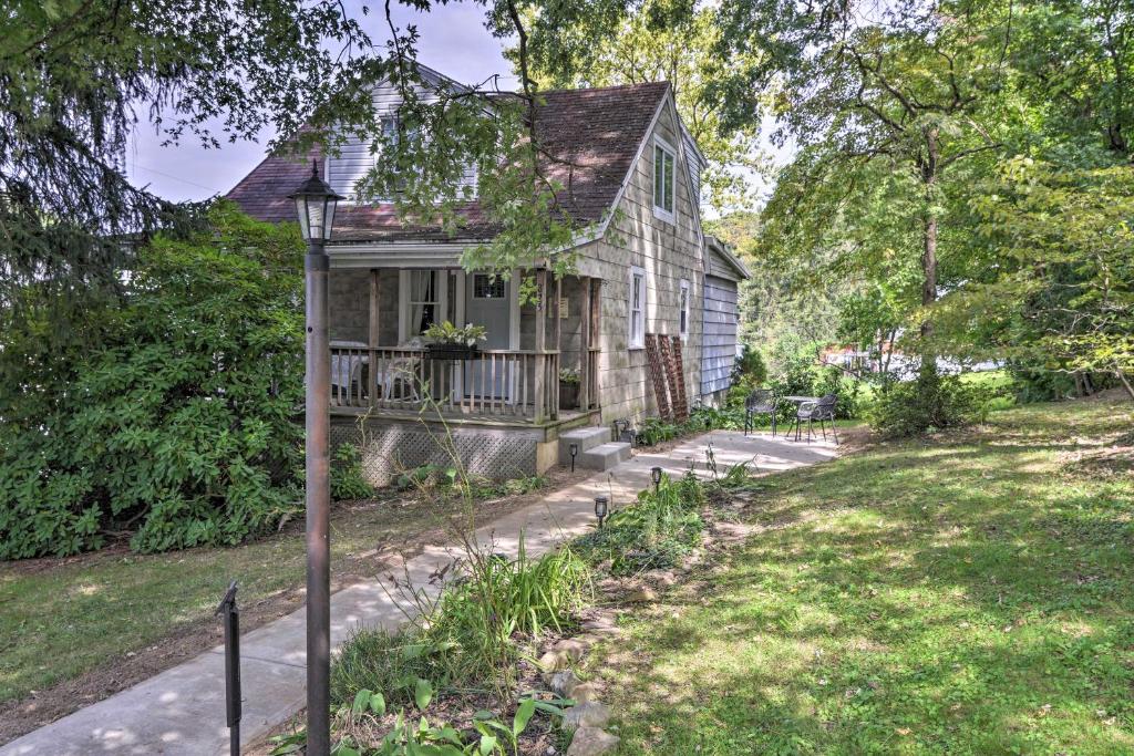 an old house with a porch and a yard at Enchanting Family House with Balcony Less Than 3 Mi to WVU! in Morgantown