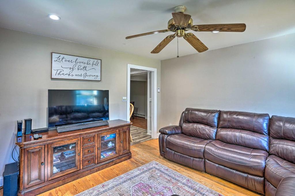 a living room with a couch and a flat screen tv at Pet-Friendly Saratoga Springs Home with Pool! in Saratoga Springs