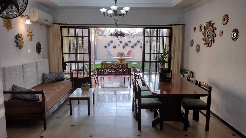 a living room with a table and a couch at SOLES Hostel Boutique in Rosario