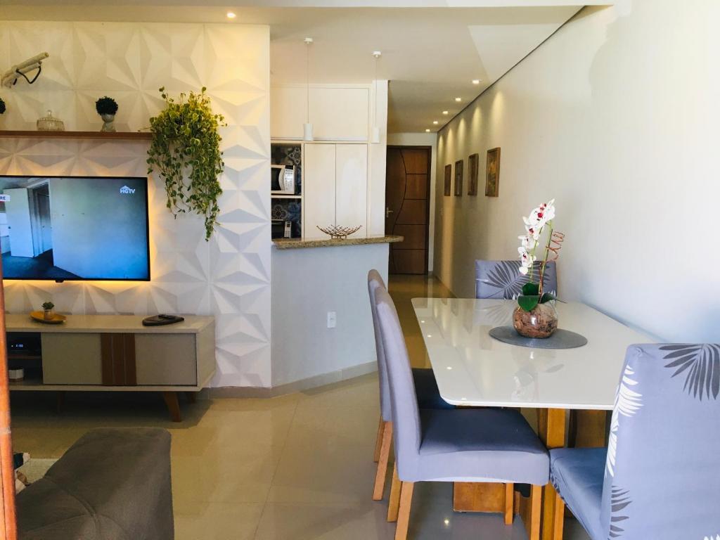 a dining room and kitchen with a table and chairs at Casa moderna de praia em Itaipuaçu RJ in Maricá
