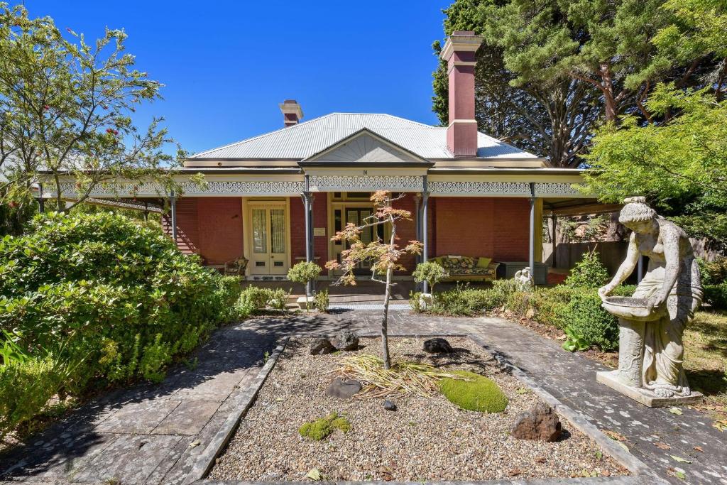 a house with a statue in front of it at Coolangatta in Katoomba