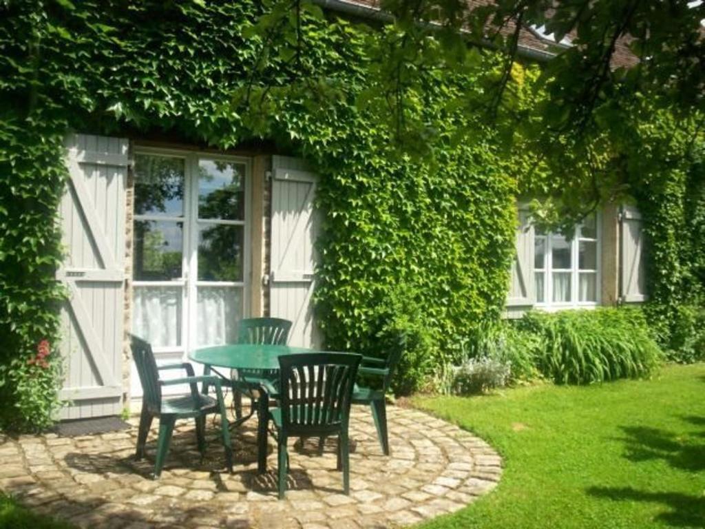 une table et des chaises devant une maison dans l'établissement Gîte Joué-l'Abbé, 4 pièces, 5 personnes - FR-1-410-128, à Joué-lʼAbbé