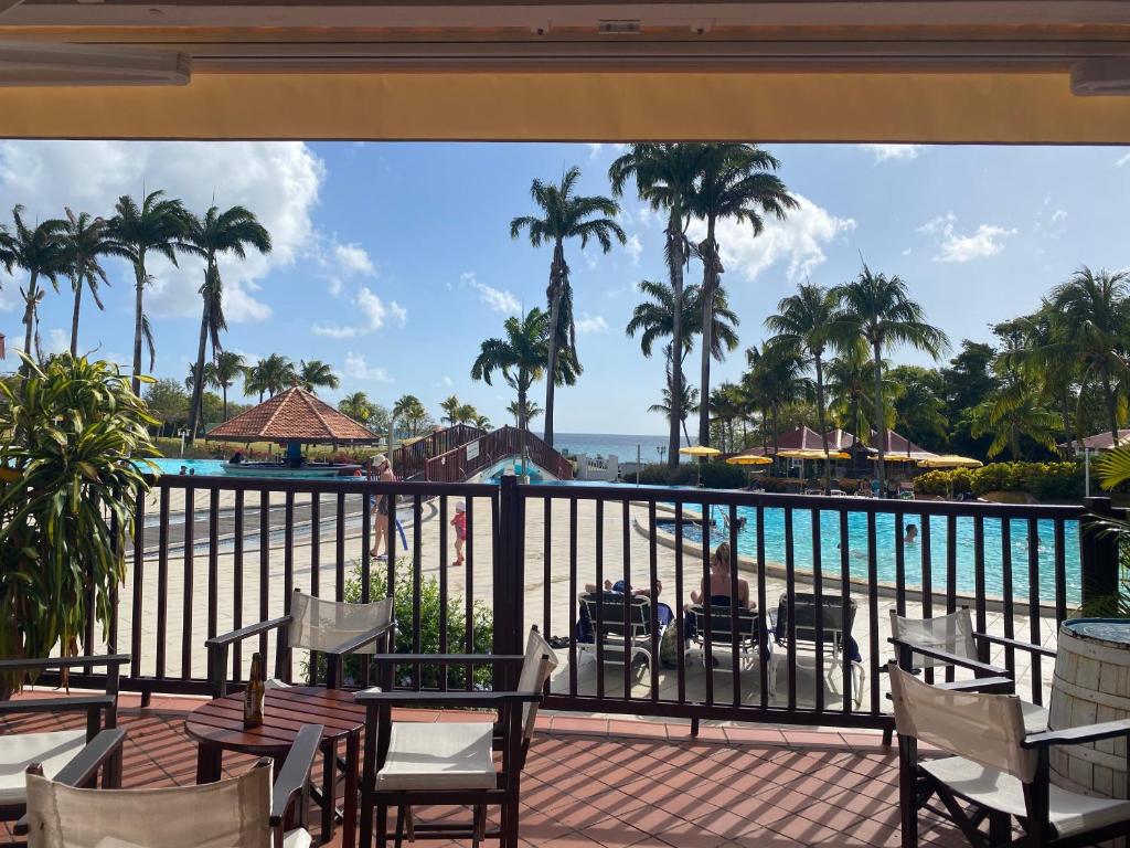 a view of the pool from the balcony of a resort at Studio RDC La Désirade Martinique accès direct plage in Sainte-Luce