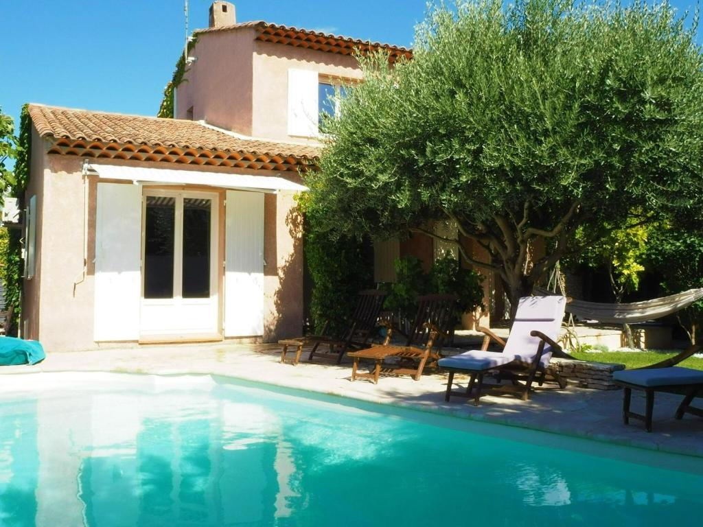 a villa with a swimming pool in front of a house at Holiday House, Pertuis in Pertuis