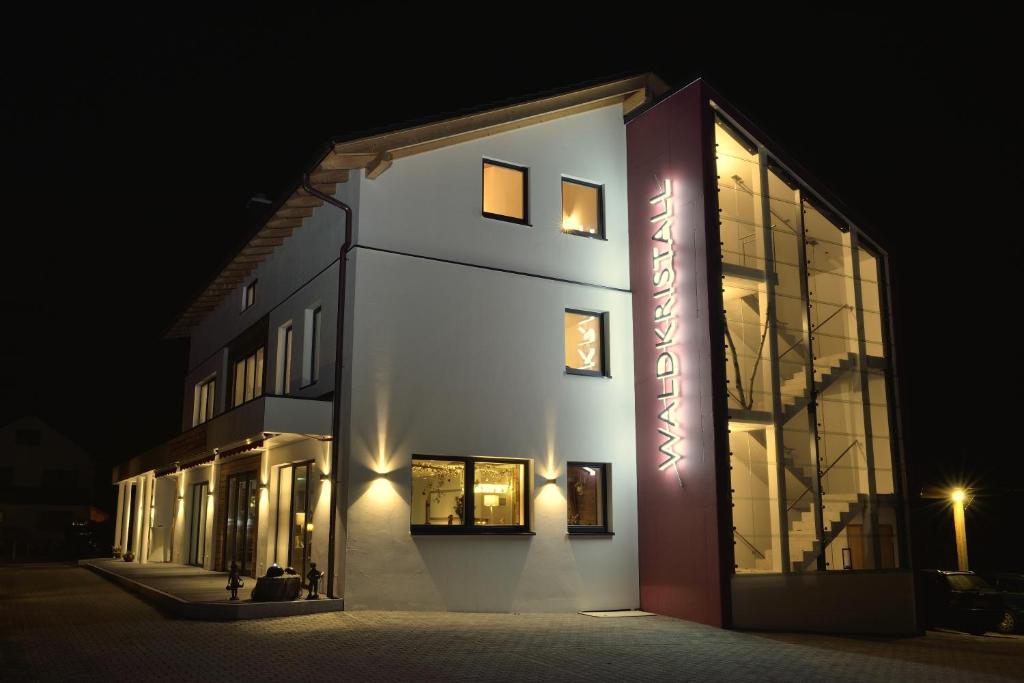 a lit up building at night with lights on it at Pension Waldkristall in Frauenau