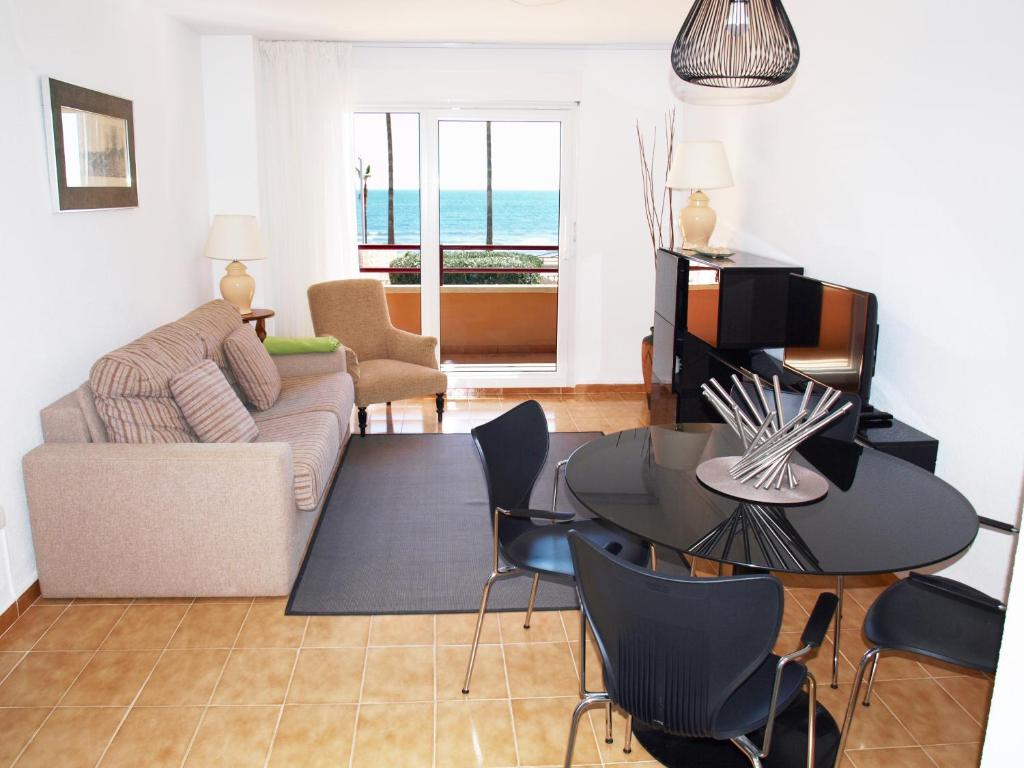 a living room with a couch and a table at ApartUP La Concha Beachfront I in Oropesa del Mar