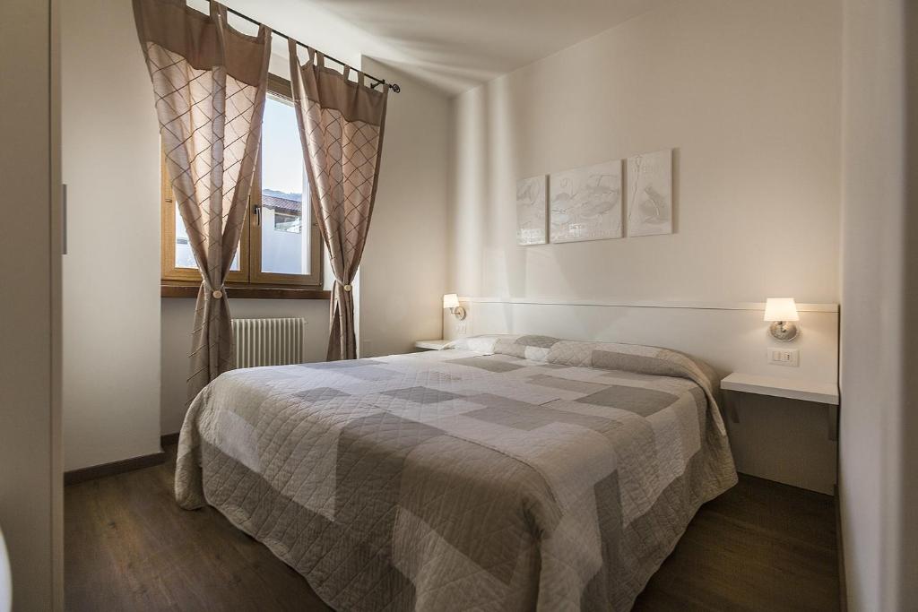 Postel nebo postele na pokoji v ubytování Le Servite Apartments