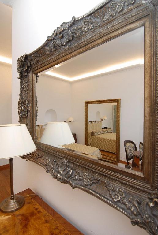 a large mirror on a wall in a bedroom at Diva La Canzone Del Mare in Capri