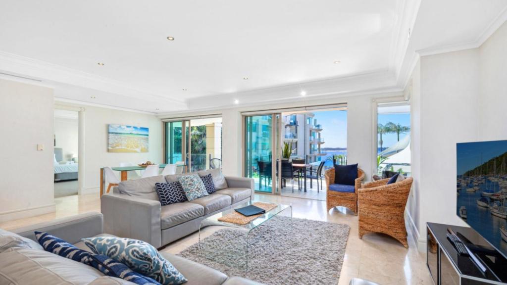 a living room with a couch and a table at Unit 21 - 3 Bed Part Ocean View in Terrigal