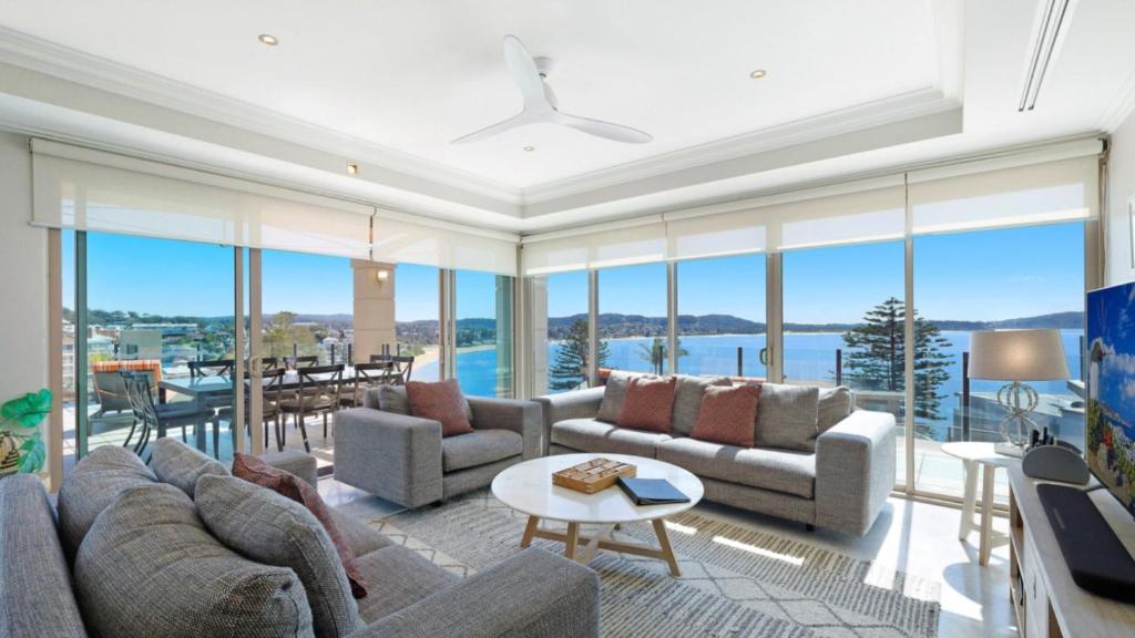 a living room with couches and a table at Unit 52 - 4 Bed Platinum Ocean View in Terrigal