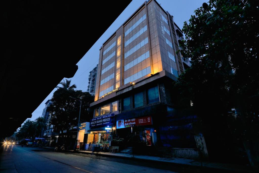 a tall building with lights on the side of it at Hotel Ariana Residency in Mumbai