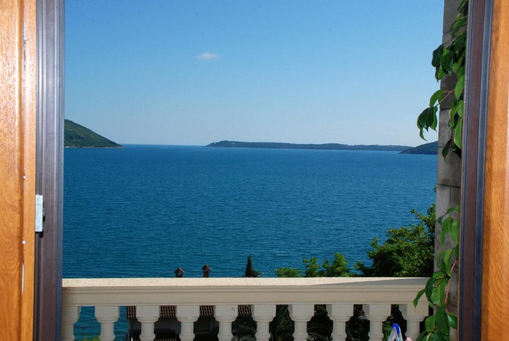 a view of the ocean from a window at Garni Hotel Bokeška Noć in Herceg-Novi