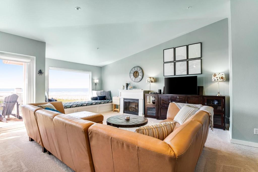 a living room with a couch and a fireplace at The Ocean Is Calling in Westport