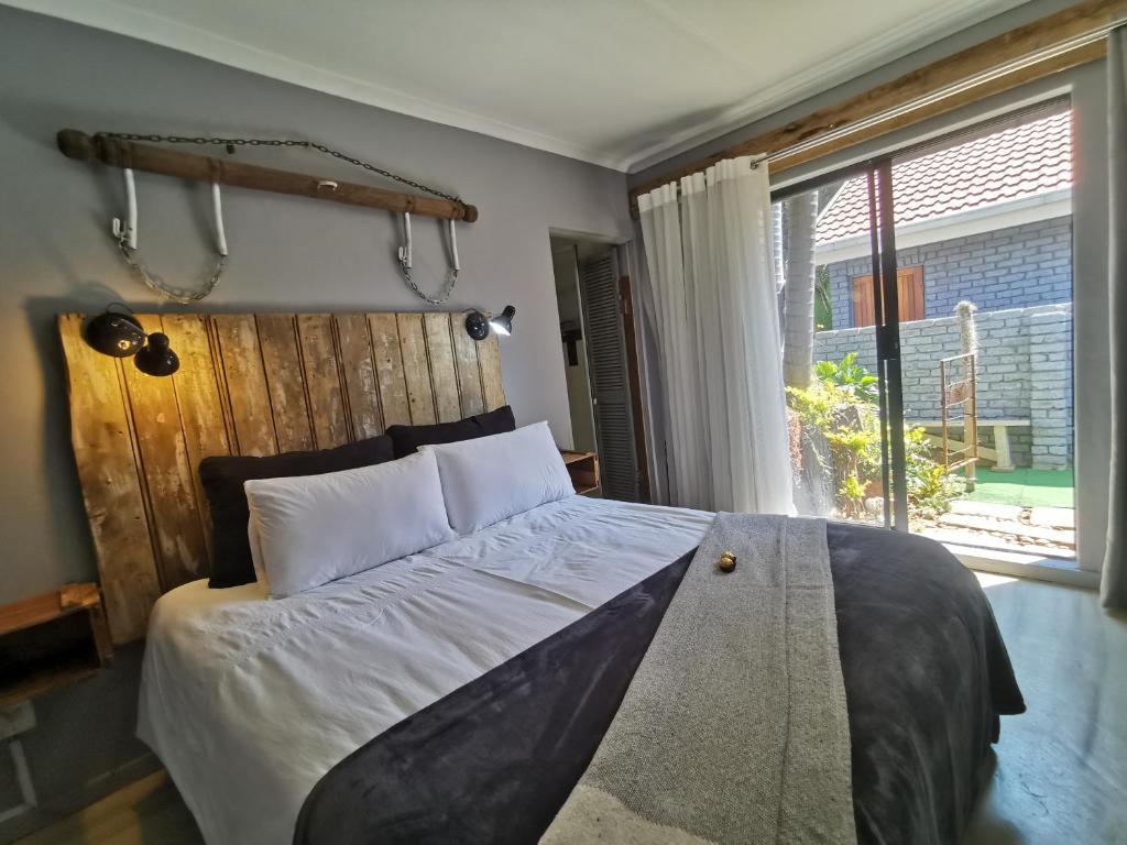 a bedroom with a large bed and a window at SomethingElz@Grace in Pretoria