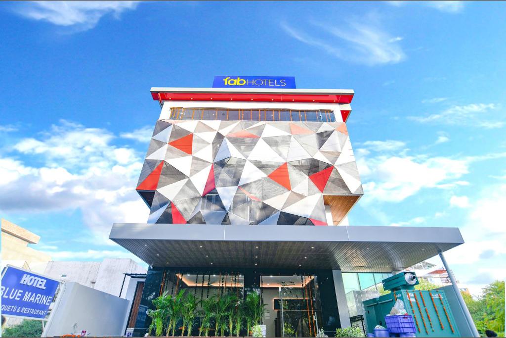 a building with a multicolored building with a sign on it at FabHotel Blue Marine in Indore