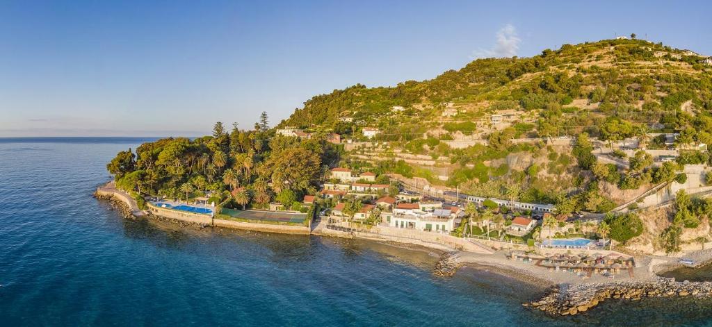 an island in the water with houses on it at Residence Baia La Ruota in Bordighera