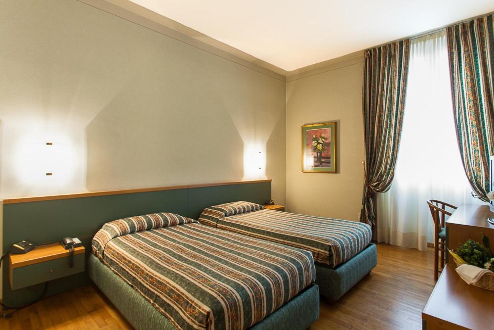Postel nebo postele na pokoji v ubytování Hotel Gambara