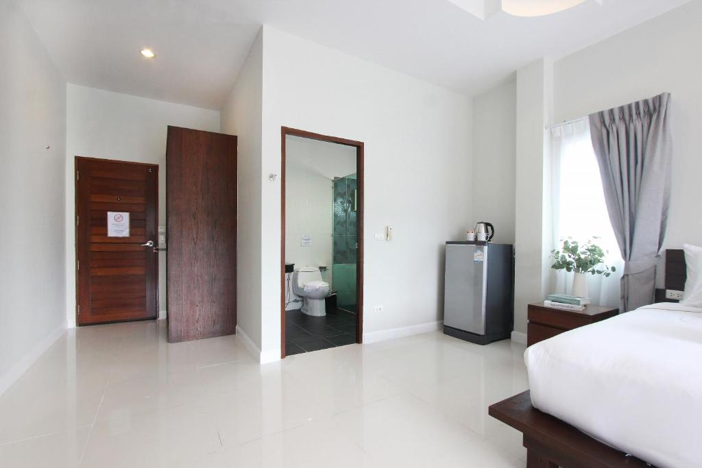 Postel nebo postele na pokoji v ubytování The Langstan Suites