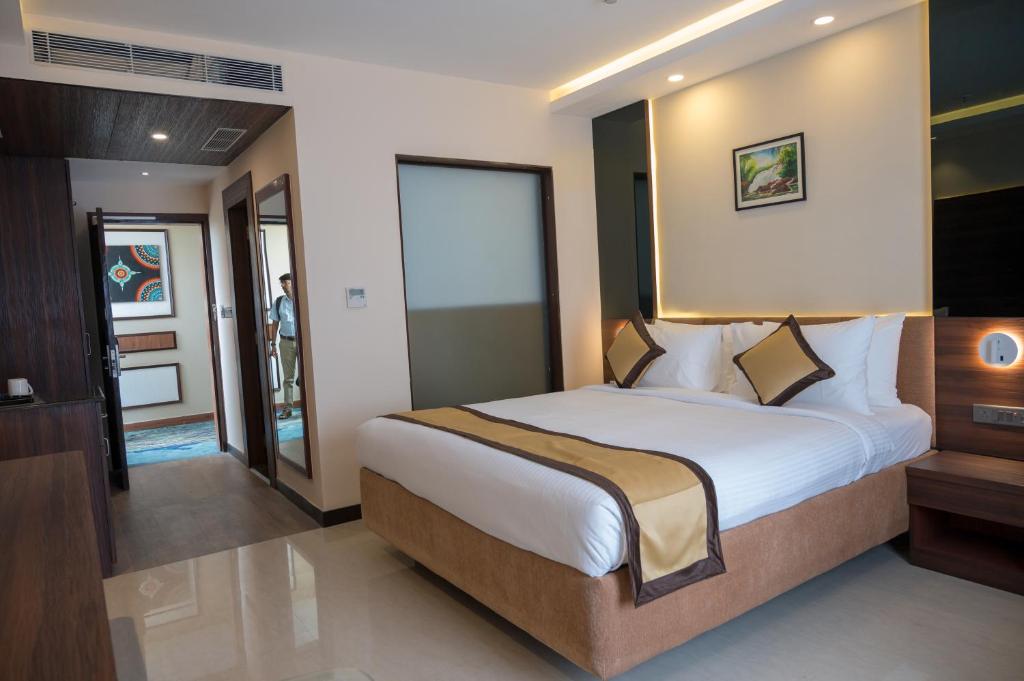 a bedroom with a large bed in a room at Golden Retreat in Baharampur