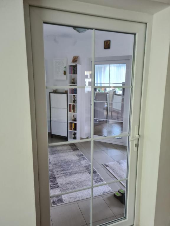 a sliding glass door in a room with a kitchen at CASA ALEX in Sărata-Monteoru