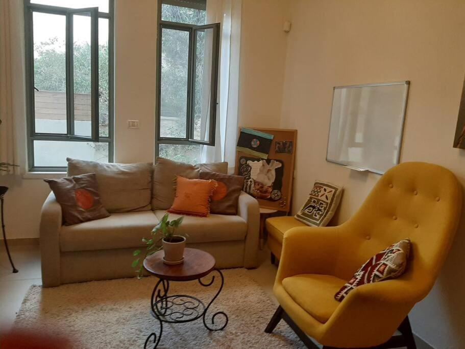 uma sala de estar com um sofá e duas cadeiras em A Spot on the Hill em Umm el Shuf
