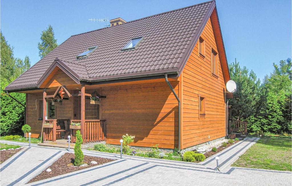 a large wooden house with a gambrel roof at Awesome Home In Pisz With Outdoor Swimming Pool in Pisz