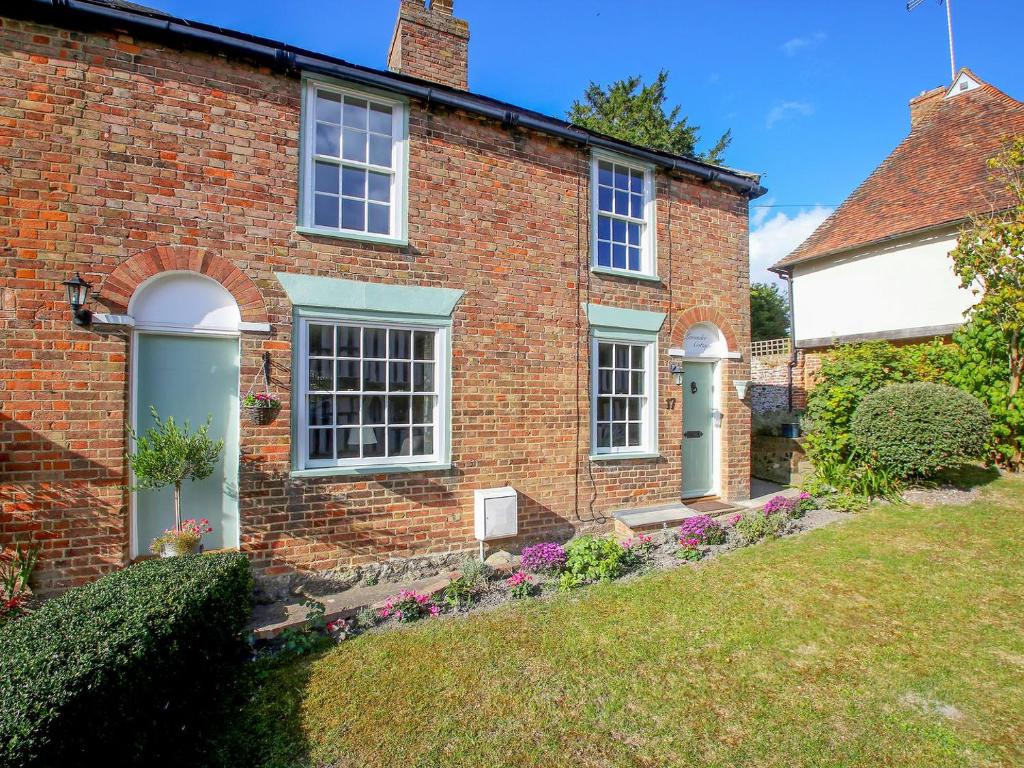 an old brick house with a garden in front of it at Pilgrim Cottage in Hollingbourne