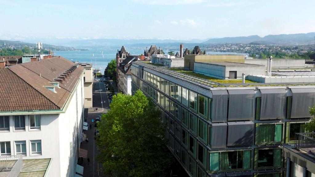 a large building with a clock on the top of it at Park Hyatt Zurich – City Center Luxury in Zurich
