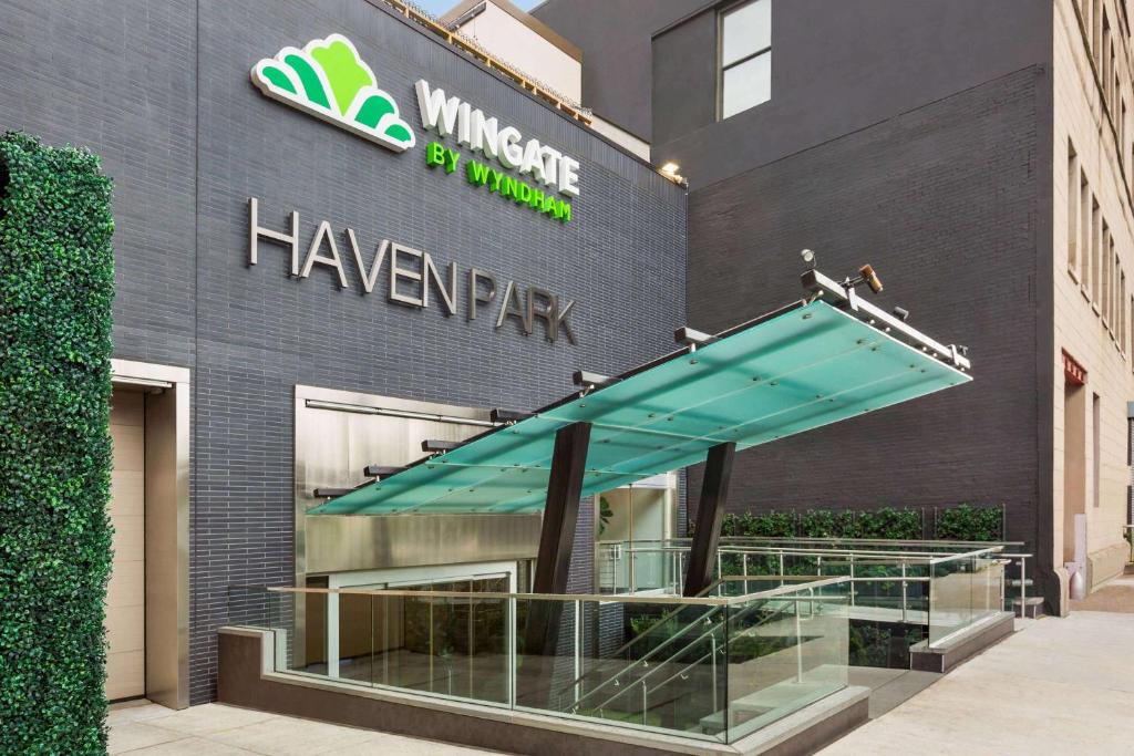 a building with awning in front of a store at Wingate by Wyndham Bronx Haven Park in Bronx