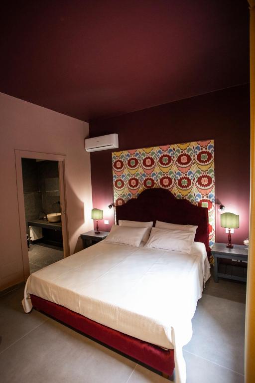 A bed or beds in a room at Citrus, between Etna and the Sea
