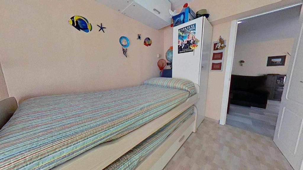 Łóżko lub łóżka w pokoju w obiekcie Atico cercano a la playa con gran terraza