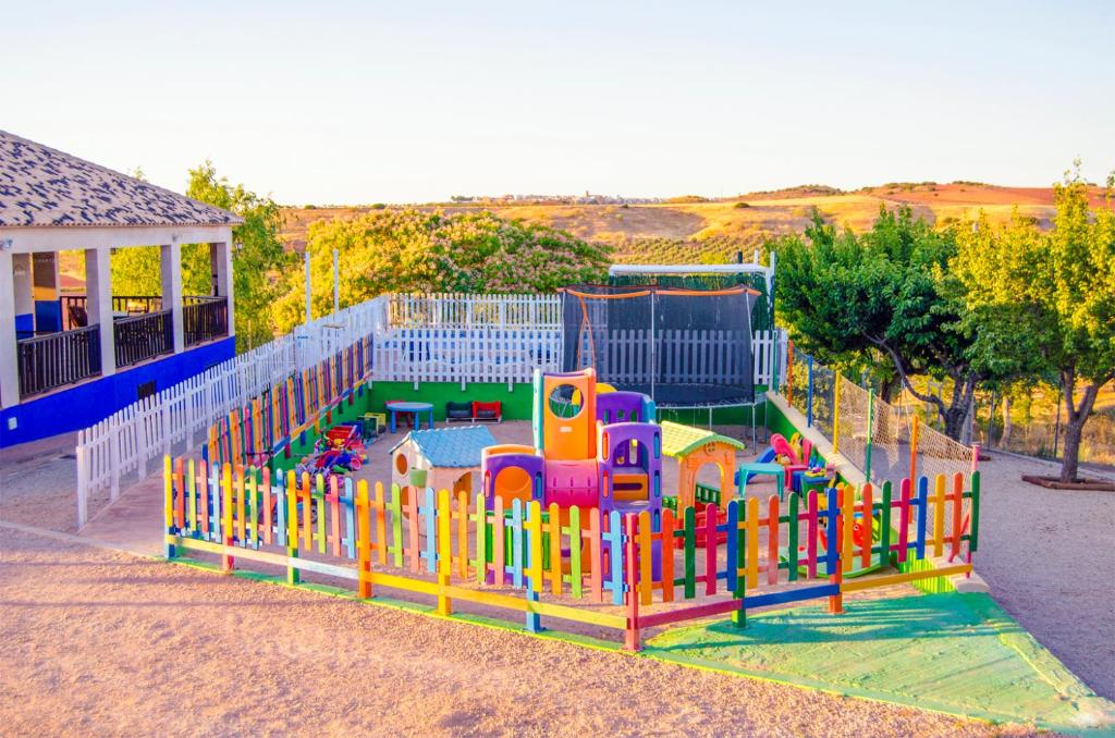 a childrens playground with a colorful play equipment at Casas Rurales Alhambra - Lagunas de Ruidera in Alhambra
