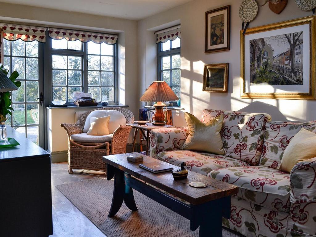 a living room with a couch and a table at Riverside Lodge in Wyck Rissington