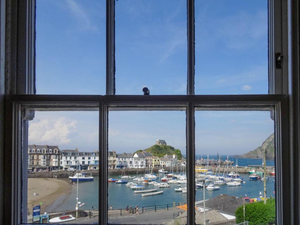 a window view of a harbor with boats in the water at Hornblower - Hddv in Ilfracombe