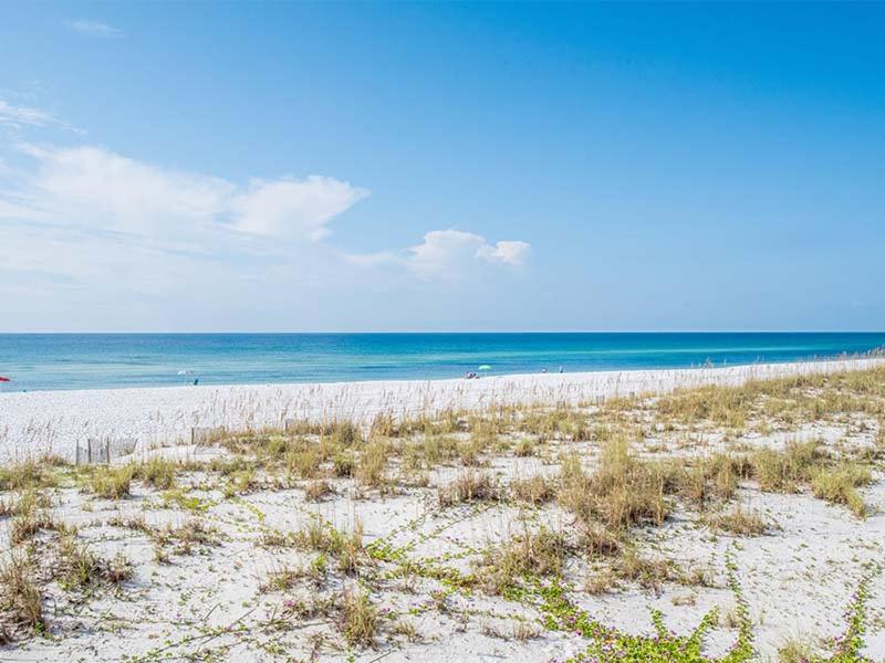 a sandy beach with the ocean in the background at Carefree 108 in Pensacola Beach