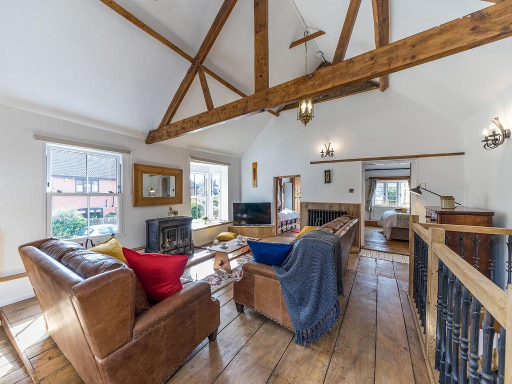 a living room with couches and a fireplace at The Old Rope Works in Bewdley