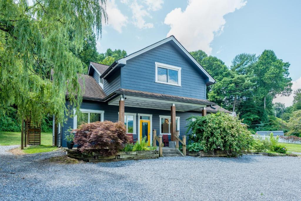 a blue house with a driveway at Old Lytle Cove Rd - Upper Unit in Swannanoa