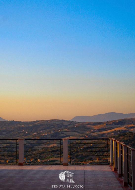 a view of the hills from a balcony at sunset at TENUTA BILUCCIO B & B in Roccadaspide