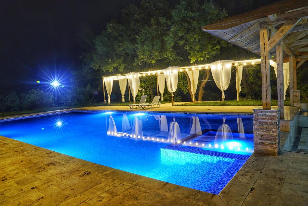 a swimming pool at night with lights on it at Sayyod Yurt Camp in Sayyod