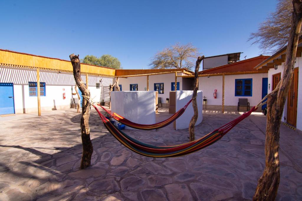a hammock in the courtyard of a building at La Rukka Hostal Boutique in San Pedro de Atacama