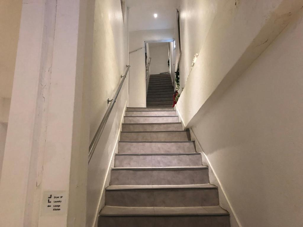 a stairway leading up to a hallway in a building at Chris Hostel in Seoul
