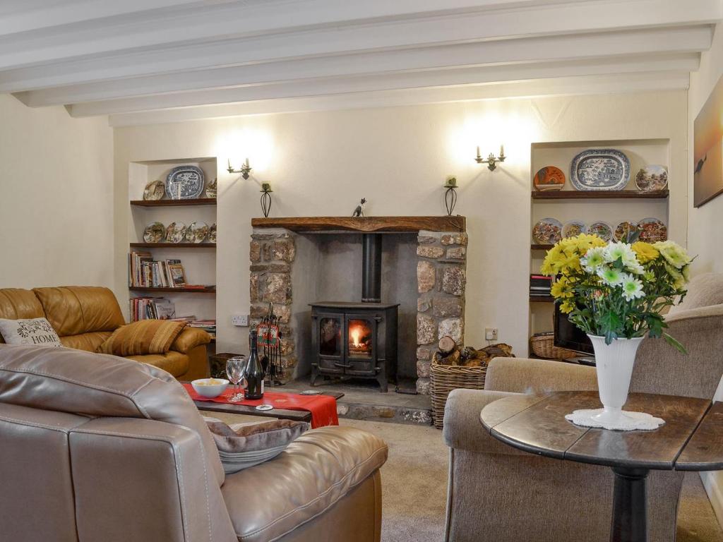 a living room with a couch and a fireplace at Middleton Hall in Rhossili