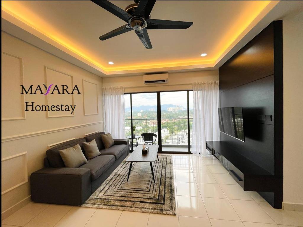 a living room with a couch and a tv at MAYARA Homestay @ Residensi Lili in Nilai