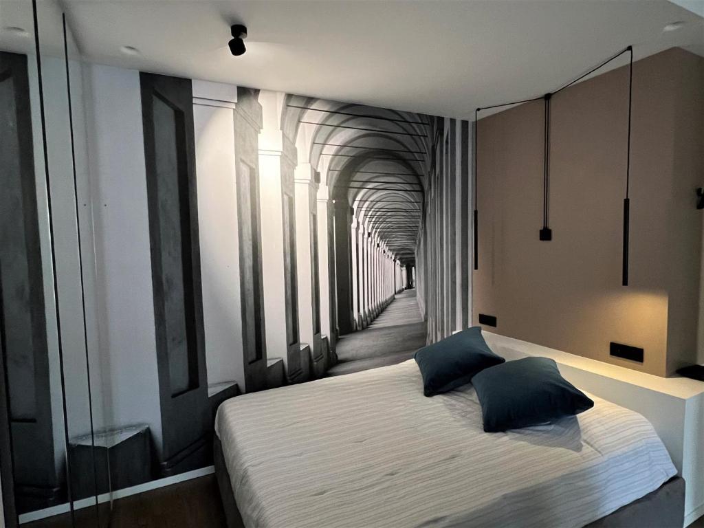 a bedroom with a bed and a hallway at Alfea Suite in Bologna