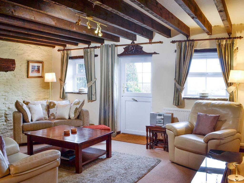 a living room with two couches and a table at Penny Croft - Uk10449 in Llangeinor